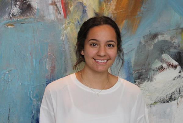 澳门足彩app实习生Camila Moreno在彩色艺术品前微笑.